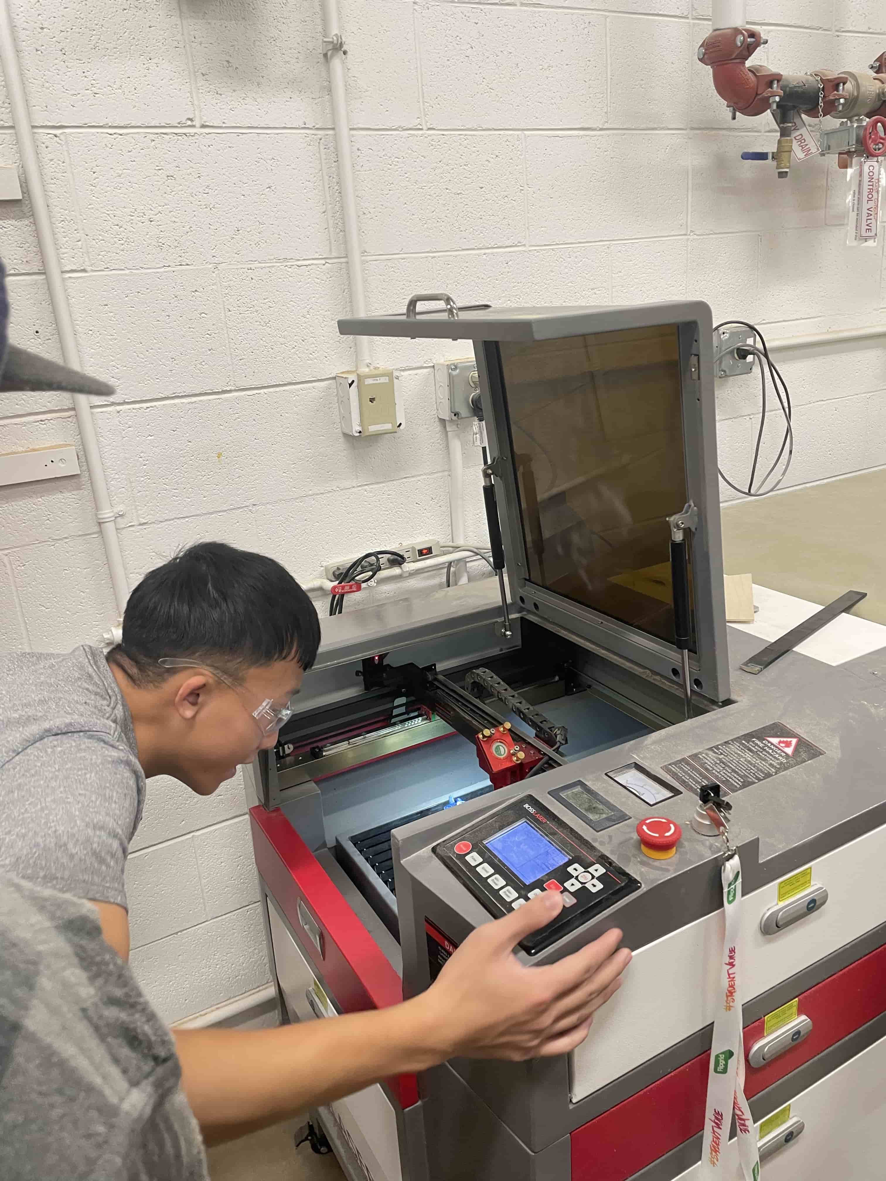 student running the laser engraver