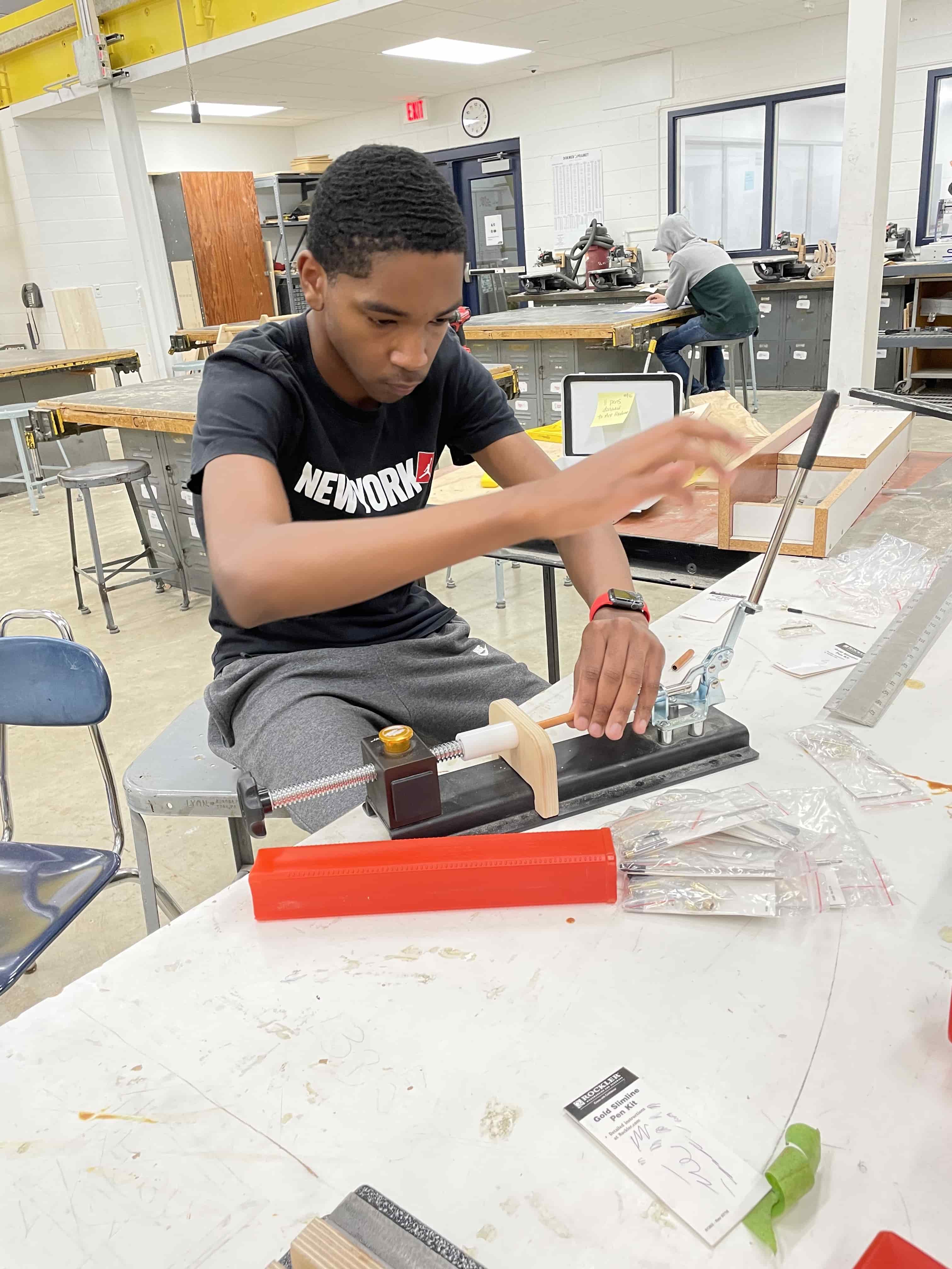 student assembling pen